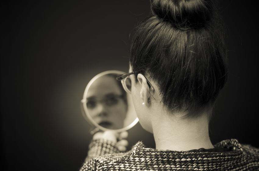 Woman Looking in the Mirror to Find Who She is in Christ