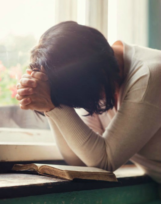 Woman Prays and Reads God's Word, Wanting to be Close to God.