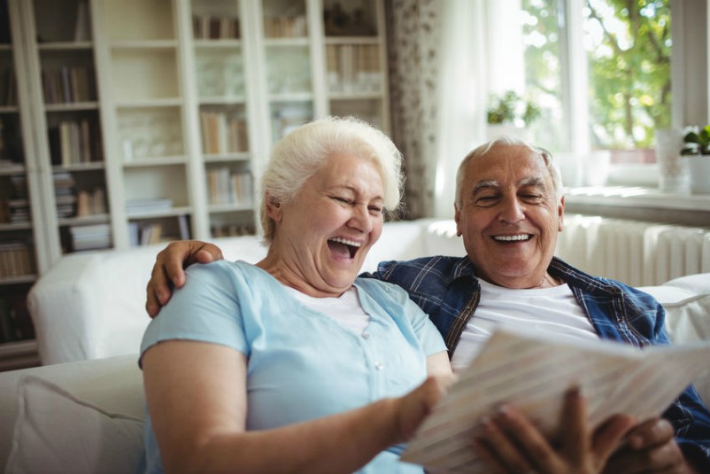 Older Couple Enjoying Family Photos