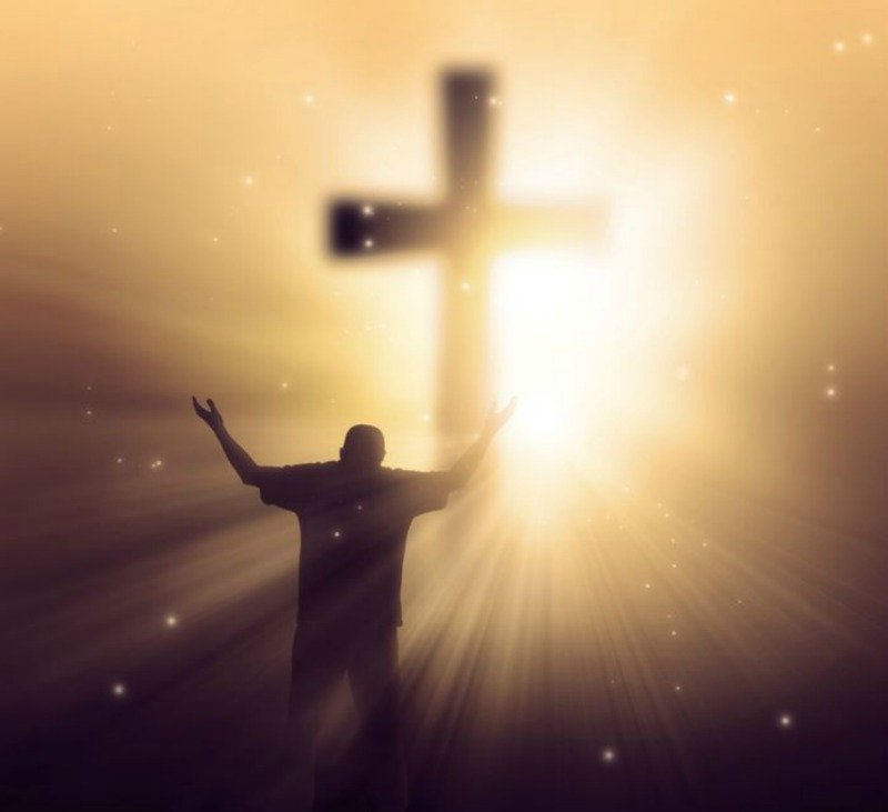 God's Light at the Cross of Jesus Christ Shines in the Heart of a Man Giving Thanks and Praise