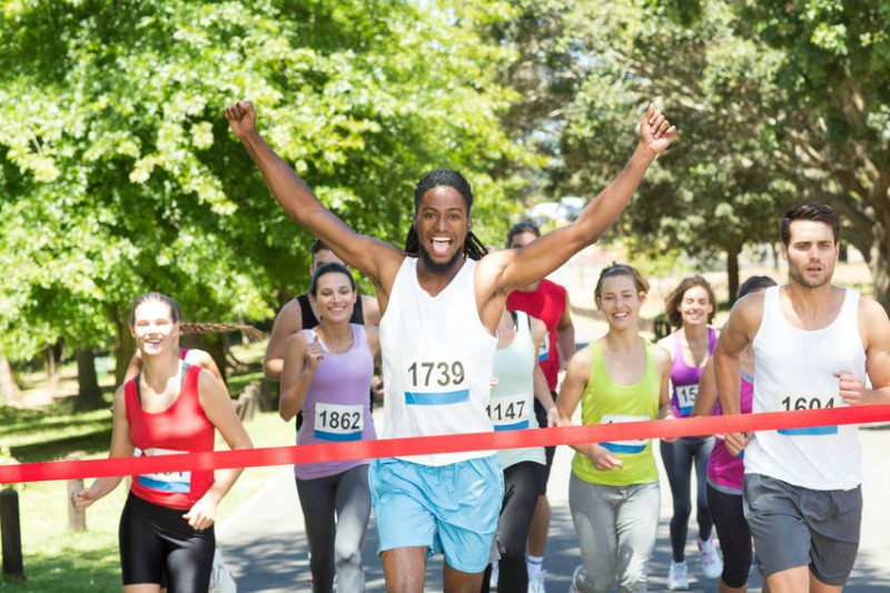 Woman Crossing Finish Line And Finishes a Winner